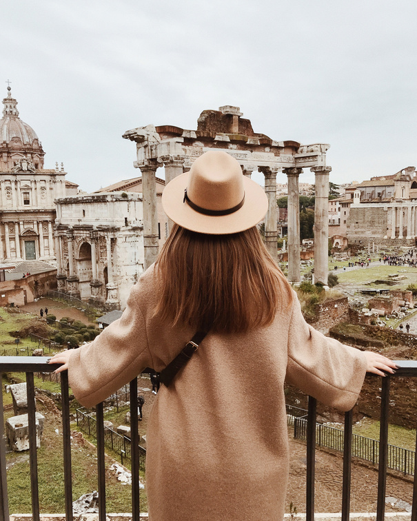 Woman in Beige Sun Hat Standing on Balcony