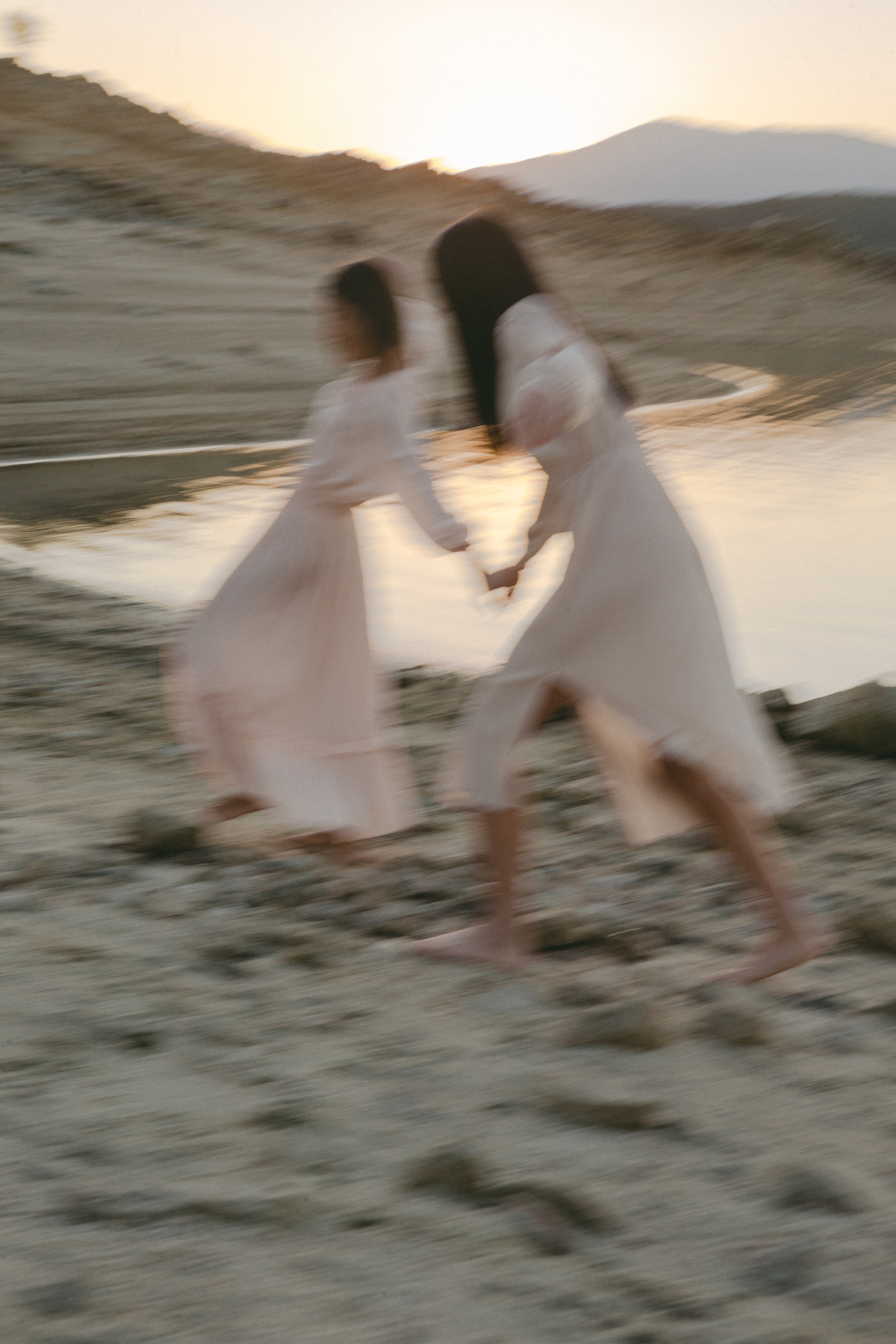 Women in Sheer Dresses Walking on the Shore