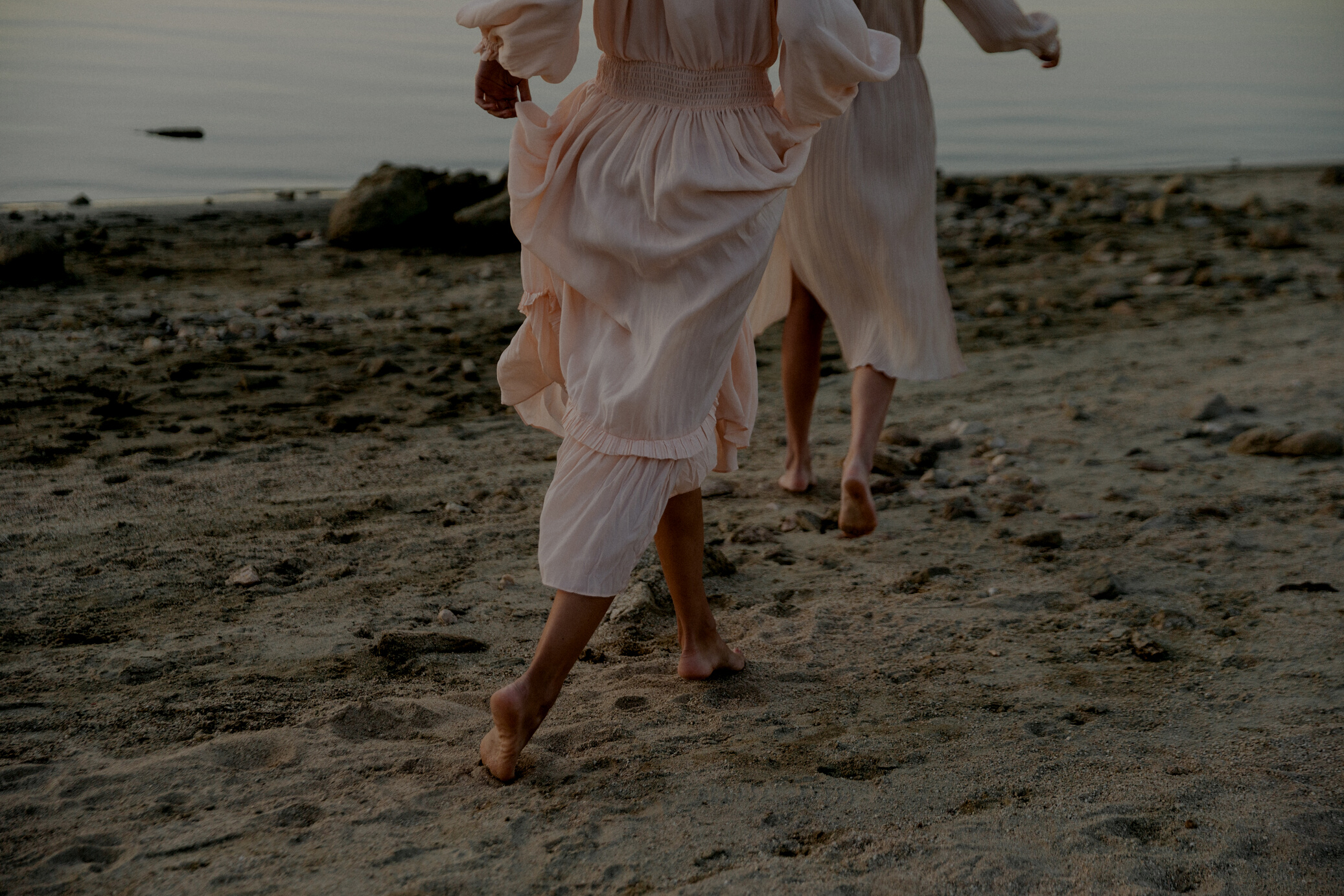 Women in Sheer Dress Walking on the Shore